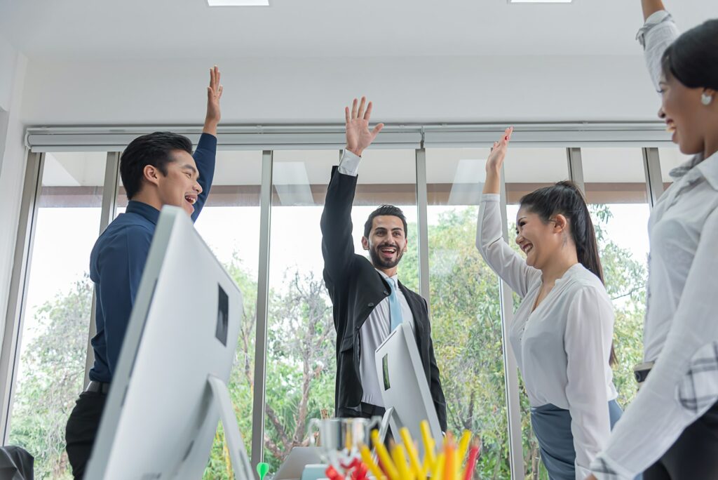 business people raise your hands together for unity,teamwork