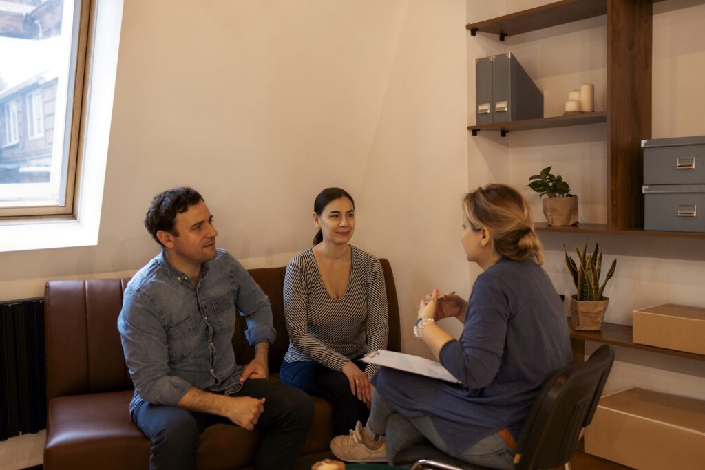 Couple visiting a psychologist and having a psychological session while dealing with problems