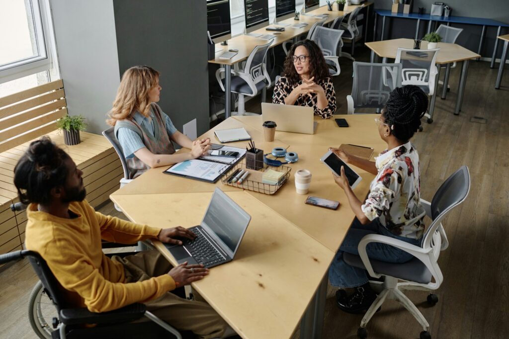 Diverse Group of Office Workers Discussing Business Project at Meeting