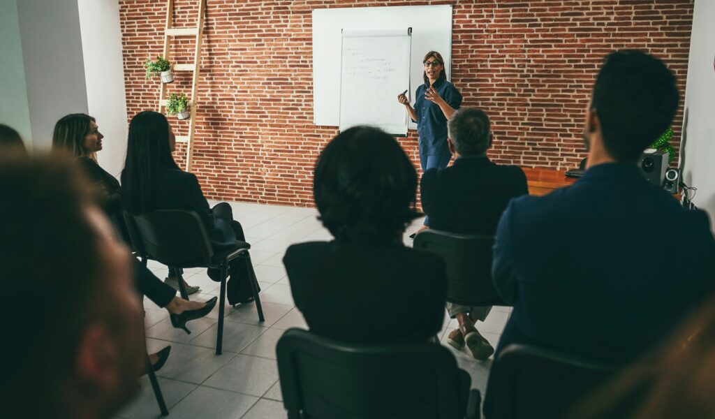 Woman coach explaining new business project at meeting event