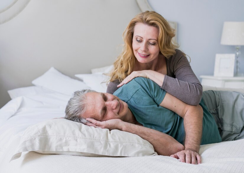 cute senior couple together in bed